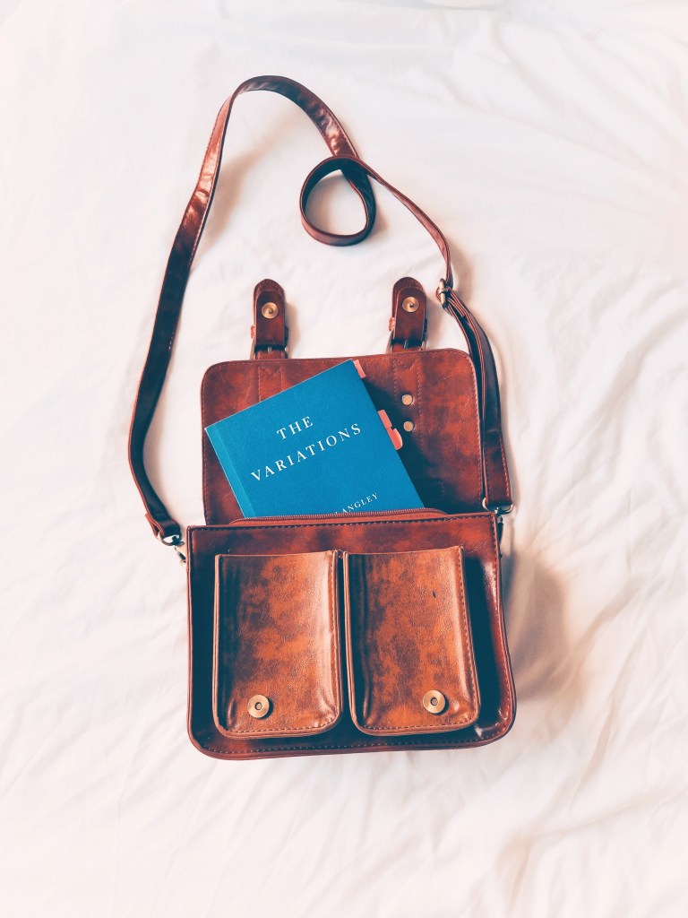 Instagram post showing leather bag with book peeking out