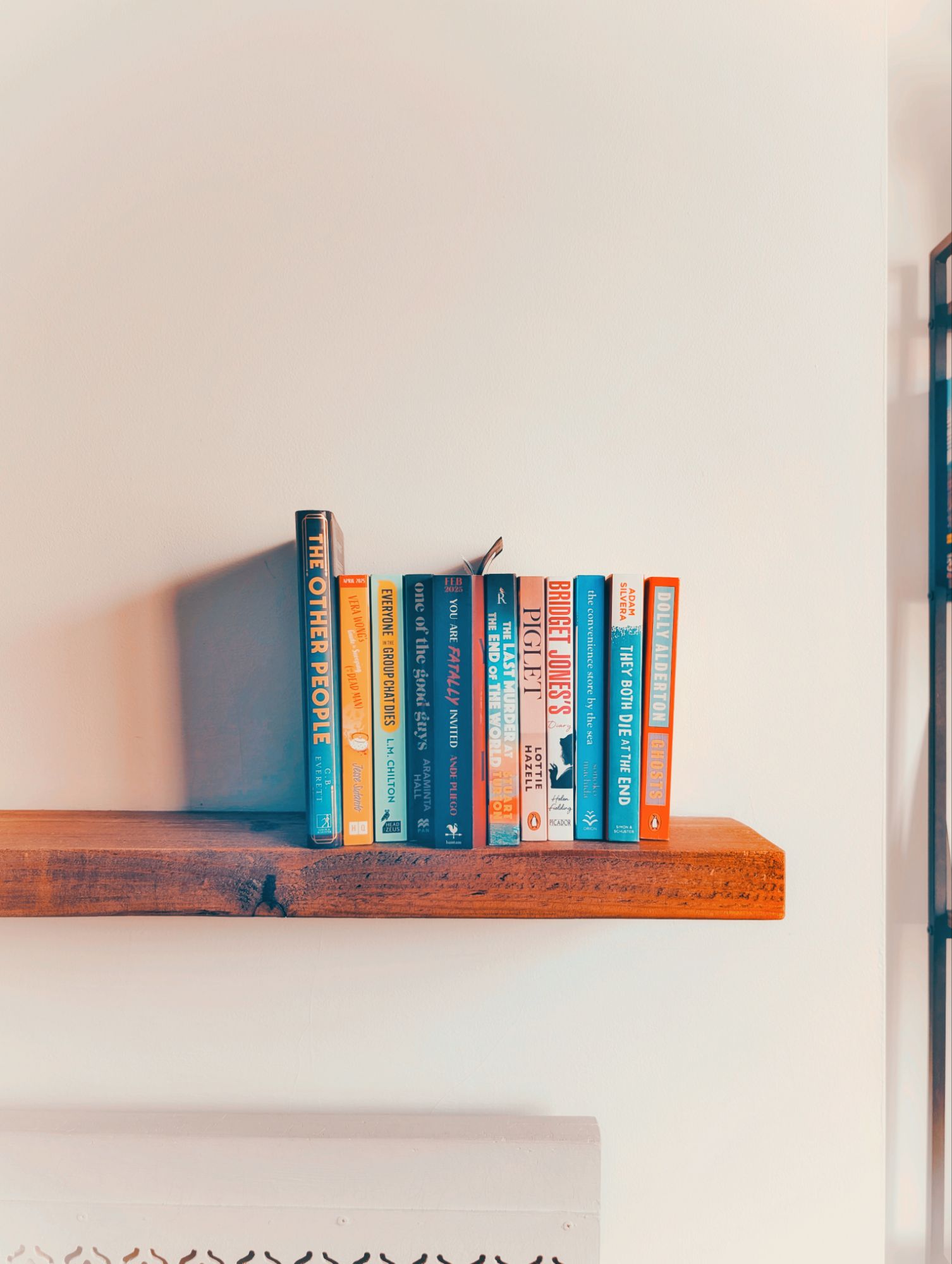 Stack of book recommendations on a wooden shelf